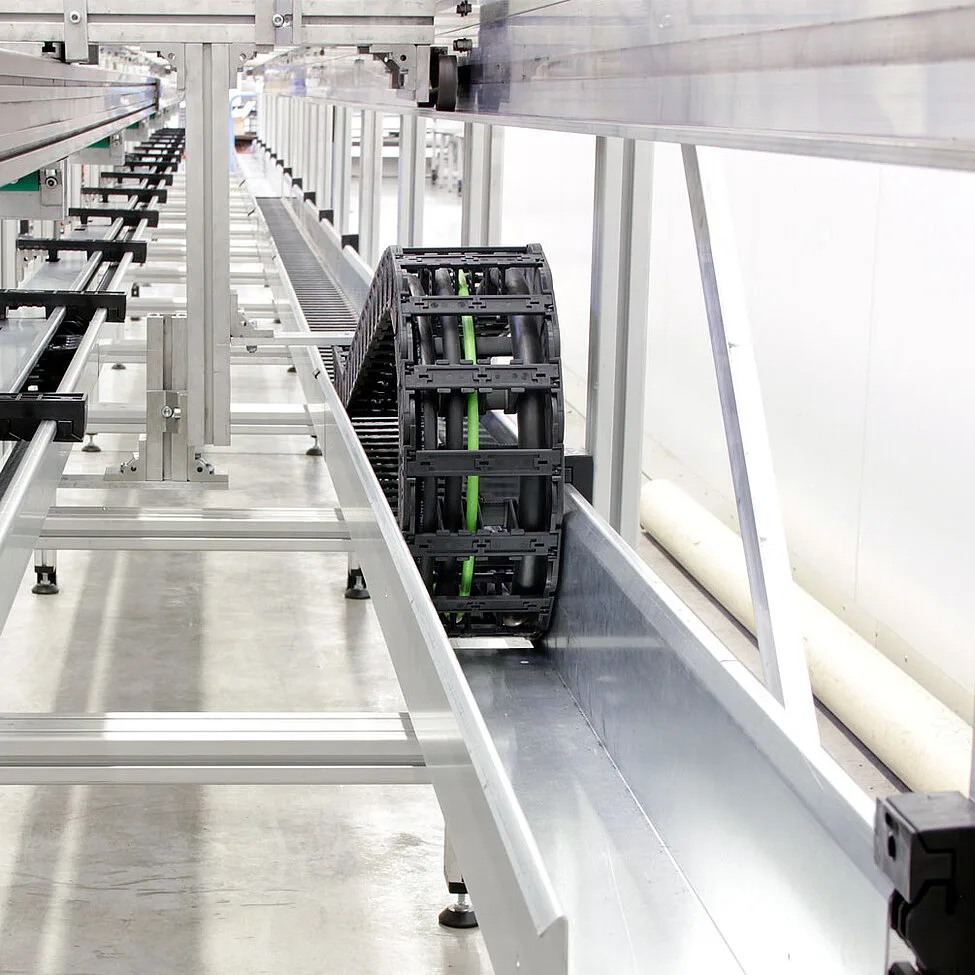 cable carrier in a guide channel on a production line