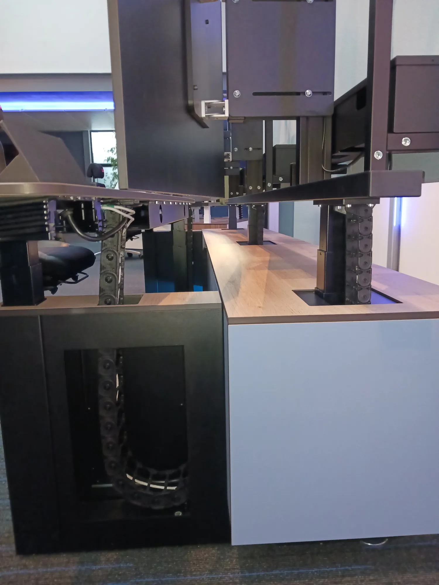 Cable carriers in the cabinet and the legs of the workstation