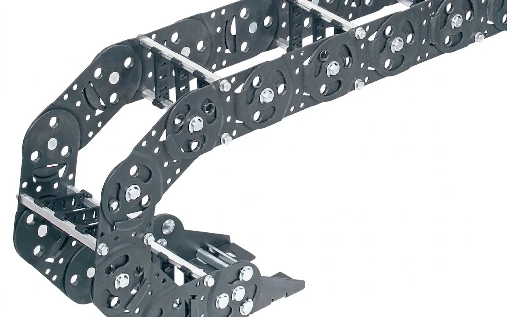 Dark grey, flexible cable carrier with metal cross connections, curved in an arc