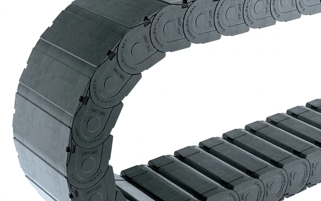 Dark grey cable carrier with rounded links and the text "UAT 1555" on a light background